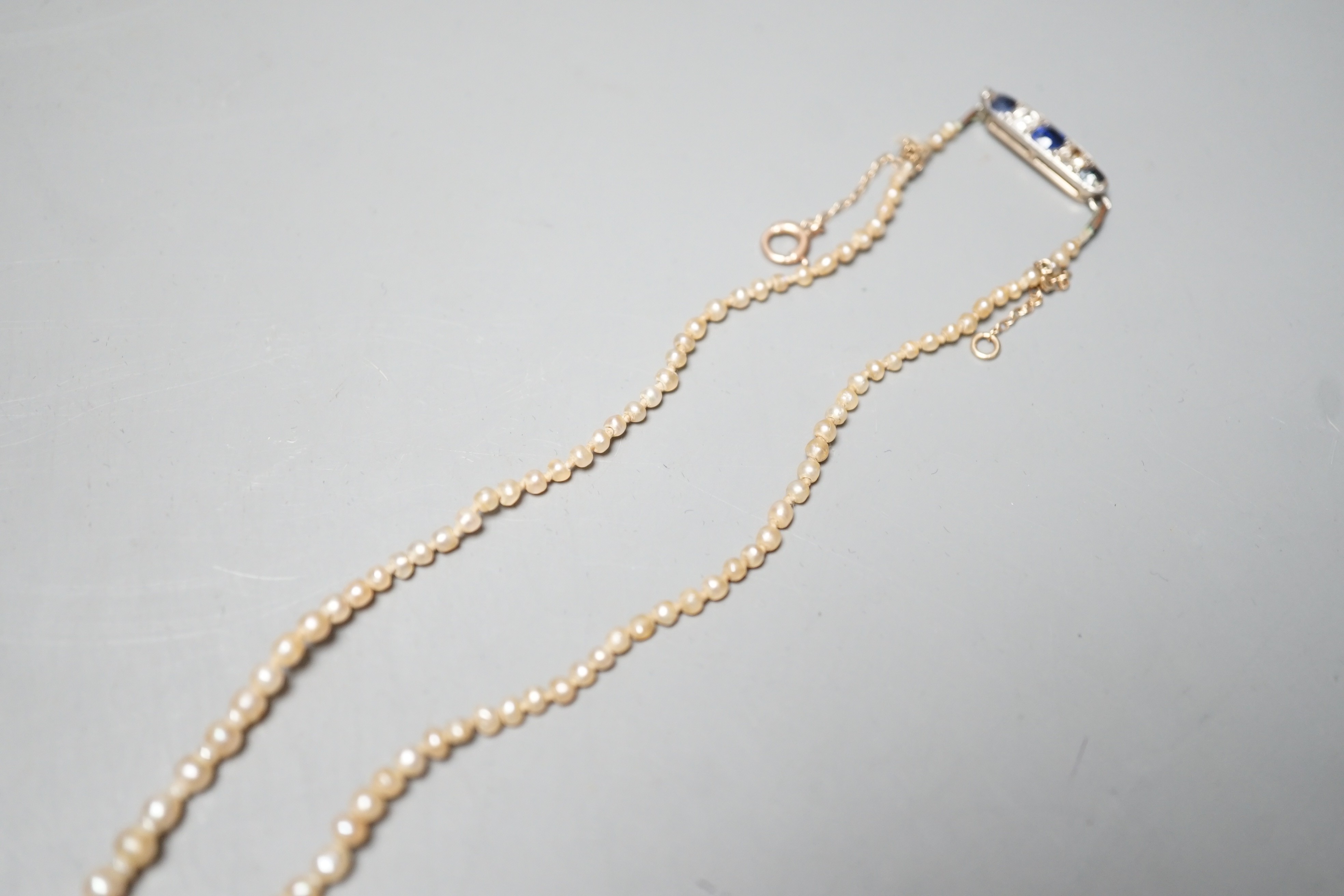 A single strand graduated natural saltwater pearl necklace, with sapphire and diamond set clasp, 44cm, gross weight 7 grams, with accompanying GCS report dated 23/11/2022.